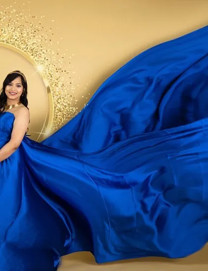 A dynamic fabric toss with a royal blue satin gown. This technique adds energy and a high-fashion feel to our studio maternity portraits.