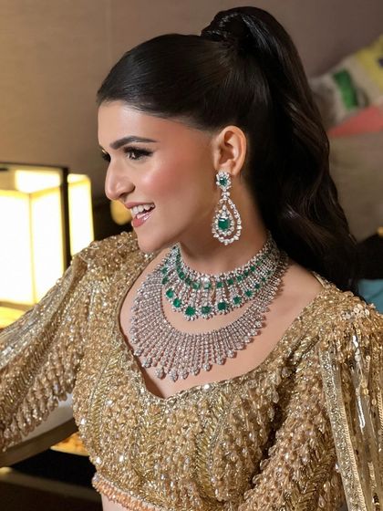 A snatched high ponytail for a cocktail night, creating a sharp and glamorous silhouette that highlights the bride's features.