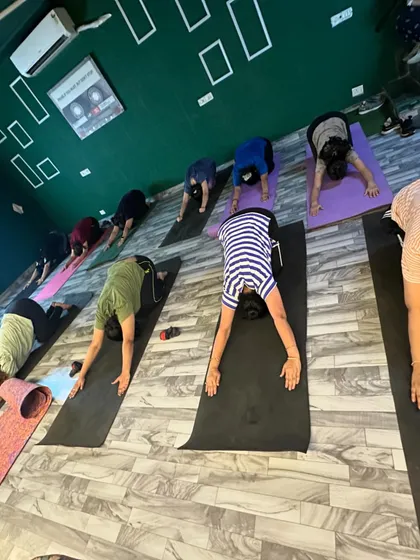 Students performing the child's pose during a cool-down session. This stretch is excellent for releasing tension in the back and shoulders after a dance workout.