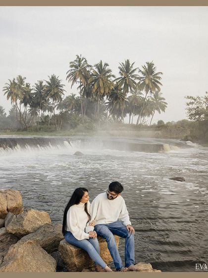 A wide shot of the couple enjoying the majestic waterfall, showcasing the beautiful scenery we incorporate into our pre-wedding photography.