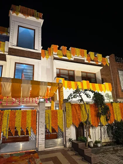 Turning a house into a 'shaadi wala ghar' is our passion. We decorated this home's exterior with cascading marigold garlands and fabric drapes, creating a festive and celebratory look that welcomes everyone.