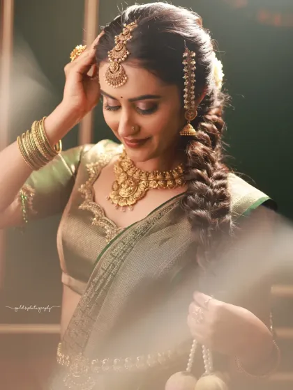 This portrait is all about soft light and a dreamy atmosphere. The focus is on the bride's gentle expression and the intricate details of her jewelry and braided hair, creating a romantic and ethereal feel.