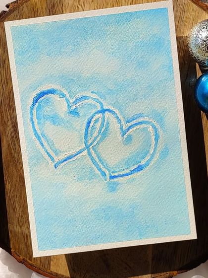 A closer look at the snowy hearts painting. The texture of the gouache gives the hearts a slightly raised, almost icy look.