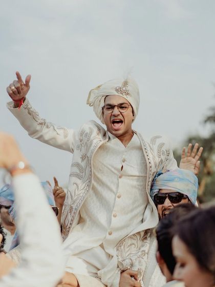 Pure excitement as the groom is lifted on his friends' shoulders during the baraat.