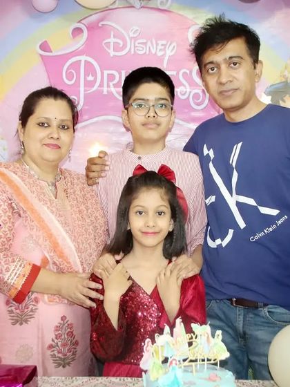 A family of four celebrating their daughter's 'Princess' themed birthday. We make sure to get a complete family picture with the cake and decorations.