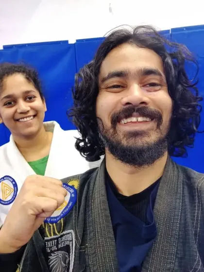 A proud coach with a student after a successful training session in the Gi.