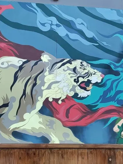 Here you can see the tiger from the Mysore mural interacting with the central figure. We designed the composition so that each element flows into the next, telling a cohesive story across the entire wall.