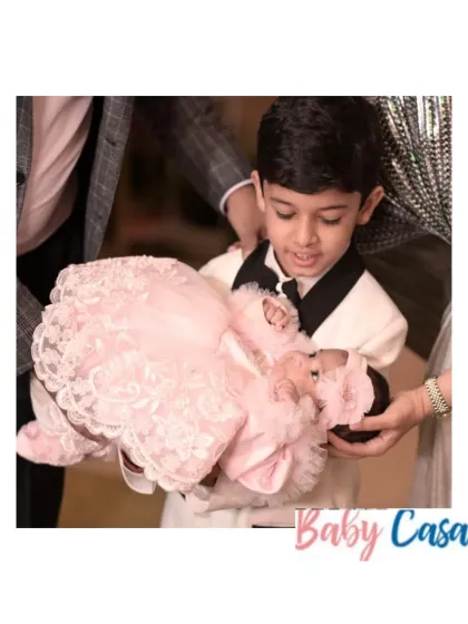 A big brother's love. We love being part of these precious family moments. Here, the siblings are dressed for a special occasion, with the baby sister in a beautiful pink lace frock.