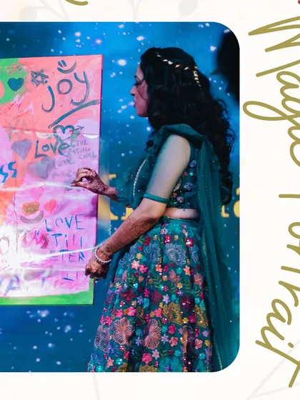 The bride adds her creative touch to the 'Magic Portrait' canvas before the big reveal. This activity is a beautiful, artistic symbol of the couple creating their new life together.