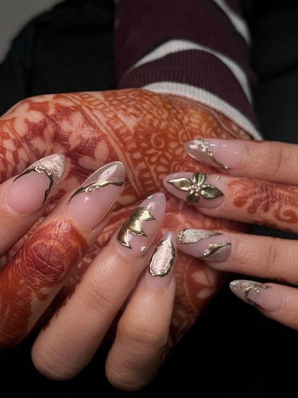 Another view of these luxurious gold bridal nails, showing how the metallic elements catch the light. This is a look fit for a queen.