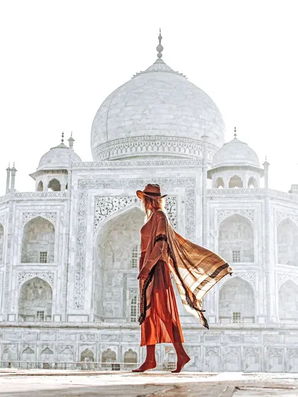 A high-key lifestyle portrait using the morning haze at the Taj Mahal. This style creates a soft, ethereal look that feels both timeless and modern.