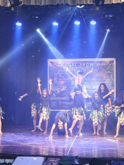 Our tribal-themed act uses earthy costumes and raw, powerful movements. This formation shows the group creating a dynamic shape around the lead dancer.