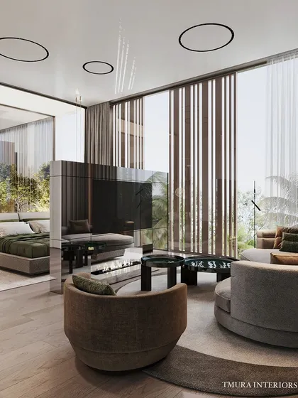 Functionality meets high design with this custom rotating television unit. Clad in reflective, high-gloss panels, it serves as a dynamic partition between the sleeping and seating areas of the bedroom, offering entertainment without compromising on aesthetic flow.