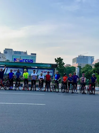 The group posing at a bus stop, a familiar sight on our long rides.