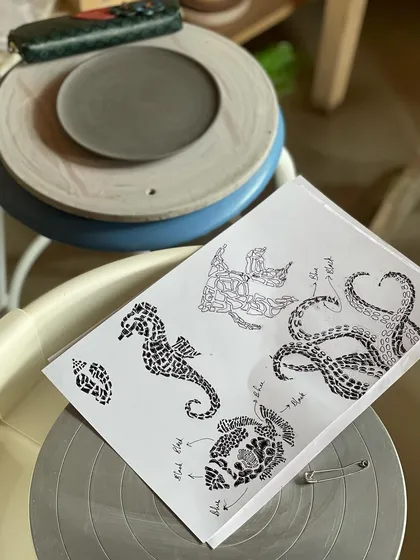 The design process is as important as the making. Here are the initial sketches and design inspirations for a student's sea themed collection, a crucial step before the clay work begins.