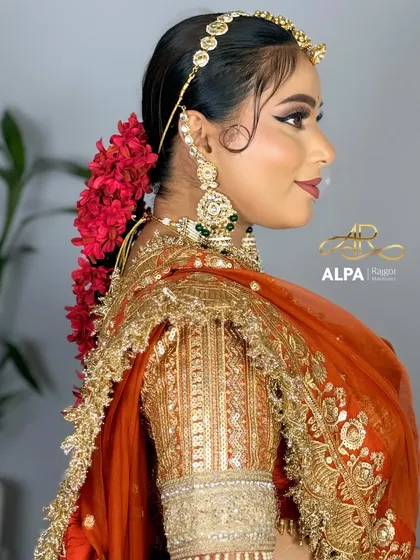 A side view that gives a full look at the floral hair accessory and the detailed blouse.
