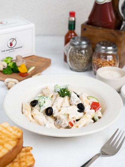For those who love creamy textures, our White Sauce Pasta is a perfect choice. Penne is tossed in a rich Alfredo sauce with broccoli, mushrooms, olives, and bell peppers.