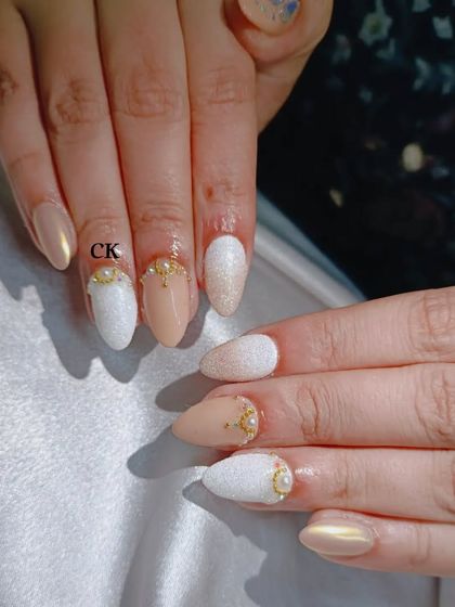 A sophisticated wedding set with nude, textured white, and gold chrome nails, accented with pearls.
