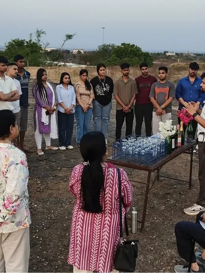 Gathered in a scenic outdoor setting, students listen intently to a lesson on wine appreciation and service etiquette. This practical workshop is a highlight of the educational tour for our IHMCT students.