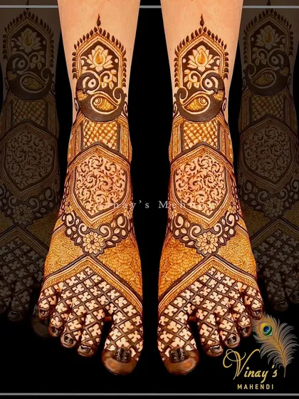A beautiful foot design with intricate paisley patterns covering the feet. The shading and line work create a rich, textured look.