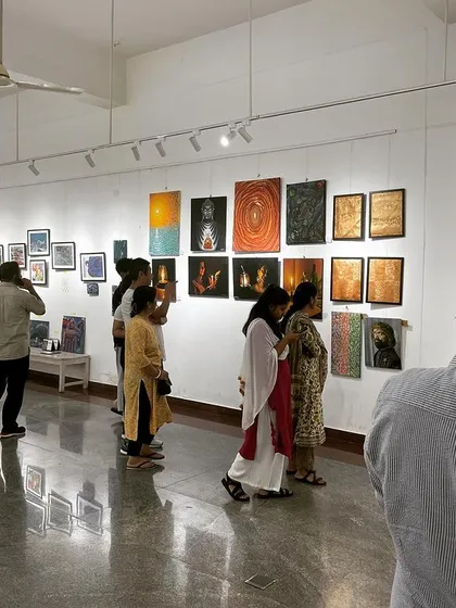 A wide shot of the bustling Rangoli Metro Art gallery during the exhibition.