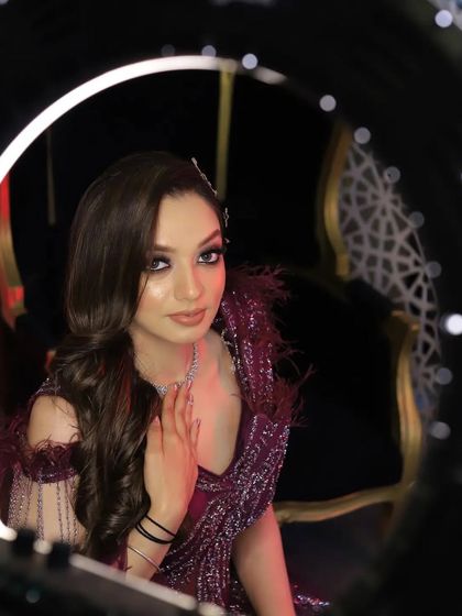 Another beautiful shot using the ring light as a frame. This angle captures the subject's confident and direct gaze, creating a powerful and engaging portrait.