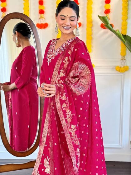 This rani pink kurta set is a classic festive look. The jacquard woven dupatta and thread embroidery on the kurta make it rich and celebratory.