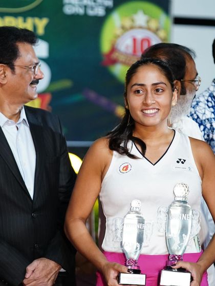 A close-up of Akanksha with her two winner's trophies, a symbol of her dedication and a great week of high-performance tennis.