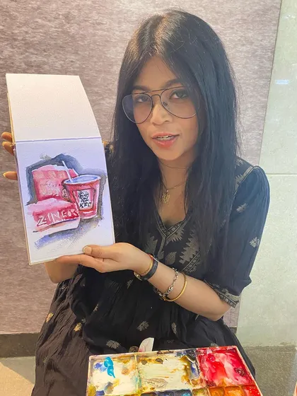 Holding up my finished snack sketch. I always carry my paints with me, so I'm ready whenever inspiration strikes.
