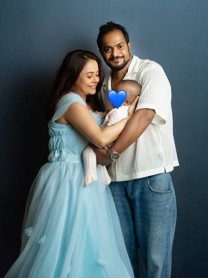 A loving family moment. The way they are gathered together, focused on their new baby, tells a story of complete adoration.