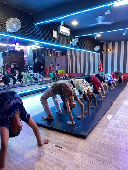 A typical day in our kids' gymnastics class. We focus on building a strong foundation with fundamental exercises like the backbend, which improves flexibility and core strength for all our young gymnasts.