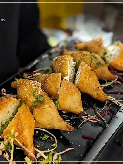 These golden-fried bread pockets are stuffed with a savory filling and sliced to show the delicious interior. They are a hearty and satisfying appetizer, perfect for events where you want to offer more substantial bites.