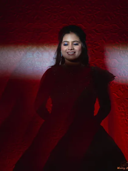 A dramatic solo portrait of the bride, Shraddha, using shadows and a single beam of light. This highlights her stunning reception look in a creative and moody style.