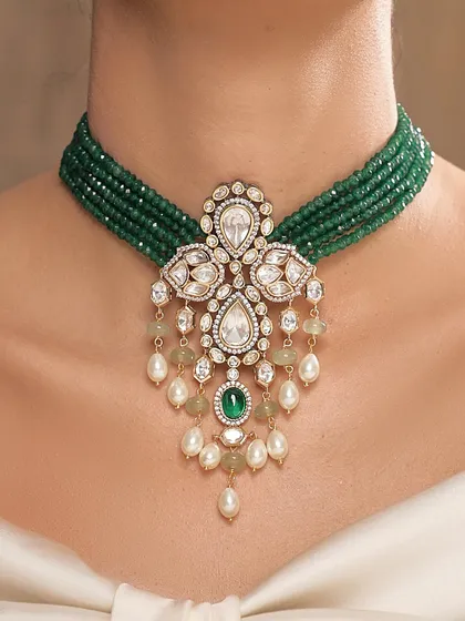 A magnificent choker from the Emrosia collection, featuring a multi-strand emerald bead necklace with a stunning polki and pearl pendant.