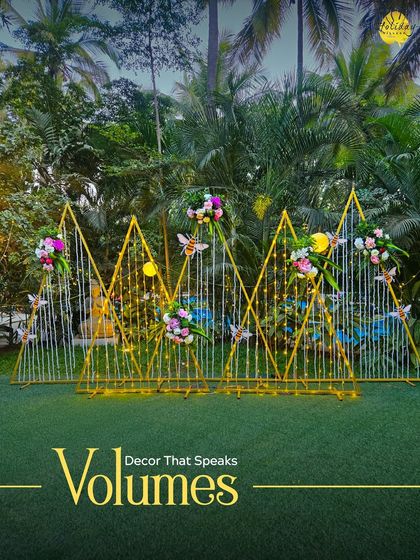 This modern, geometric decor piece with floral accents and fairy lights serves as a unique photo backdrop or stage element, showing how we accommodate contemporary styles.