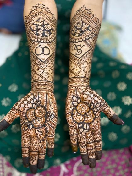 An elegant design featuring the couple's initials, 'AS', and wedding rings, set within diamond-shaped frames on the back of the hands.