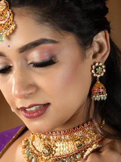 A detailed close-up from a jewellery campaign. The makeup is designed to enhance the model's features while ensuring the stunning antique jewellery remains the hero of the shot.