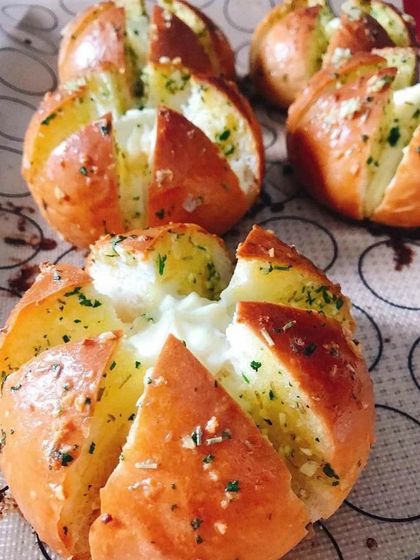 Freshly baked Korean Cream Cheese Buns, straight out of the oven. The buns are golden brown and filled with melted cream cheese.