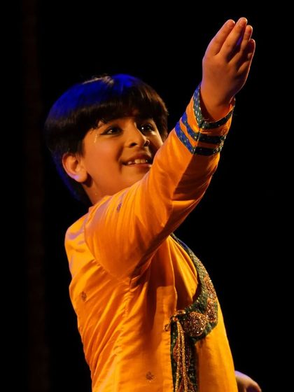 A young male student performing with a bright smile at the Kanasu festival. It's wonderful to see boys embrace this art form.