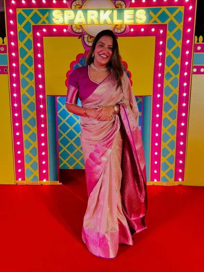 Sparkle and shine, it's Diwali time! Dressed in a festive pink and beige saree for a special celebration.