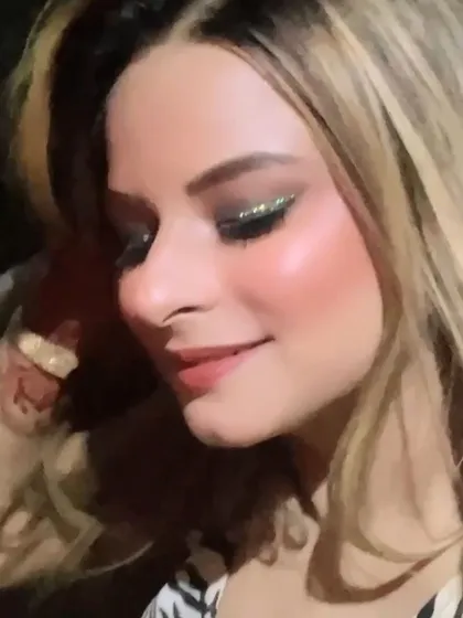 A close-up of a dramatic cocktail look, featuring a black and green glitter smokey eye. Perfect for a night of glamour.
