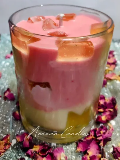 Layered with love and topped with charm, our handcrafted soy candle is a treat for the senses. This layered pink and white candle is decorated with dried rose petals.
