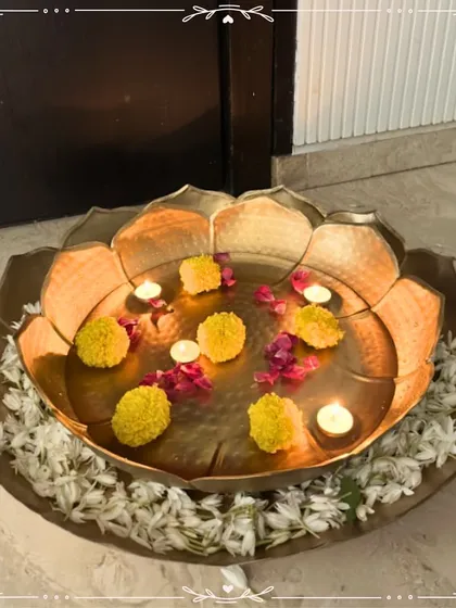 I love creating pieces that bring tranquility and beauty to your home. This large, handcrafted metal urli, styled with floating marigolds and tea lights, creates a serene and welcoming centerpiece, perfect for any festive occasion or to simply elevate your daily living space.