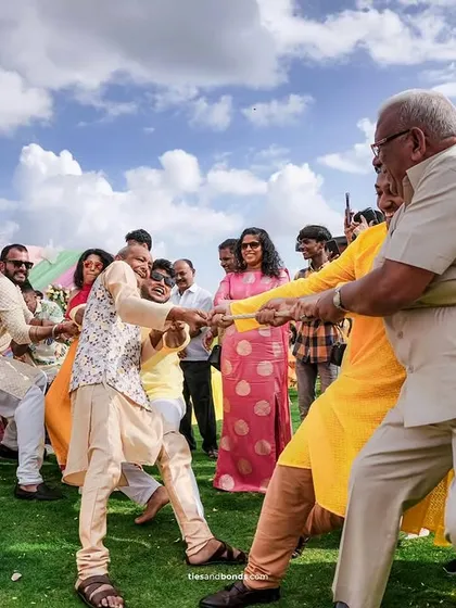 The ultimate family fun: a game of tug-of-war at a Haldi event. We plan activities that get everyone involved and laughing.