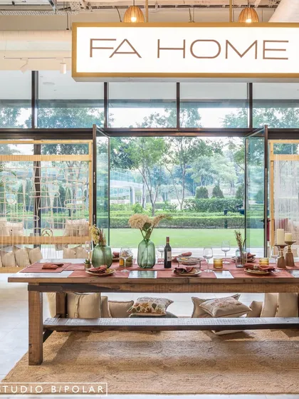 In designing the FA Home retail store, we framed the view of the lush outdoors to create a living backdrop for the dining display. This connection to nature enhances the sense of tranquility and luxury, allowing the brand's artisanal home furnishings to be presented in a serene, aspirational setting.