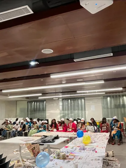The setup for the cap painting workshop at HBC, with tables covered in newspaper, ready for the creative mess to begin.
