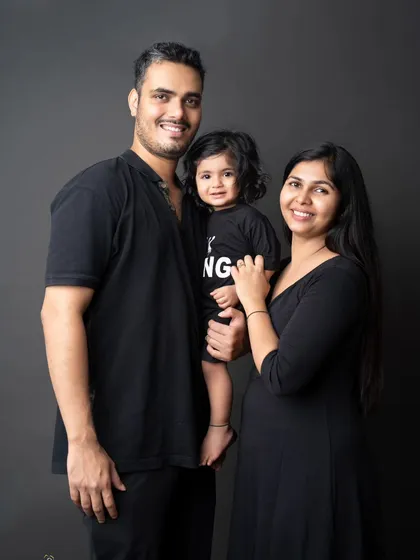 A beautiful family, captured in a moment of pure happiness. Their coordinated black outfits create a classic, timeless portrait that focuses on their connection.