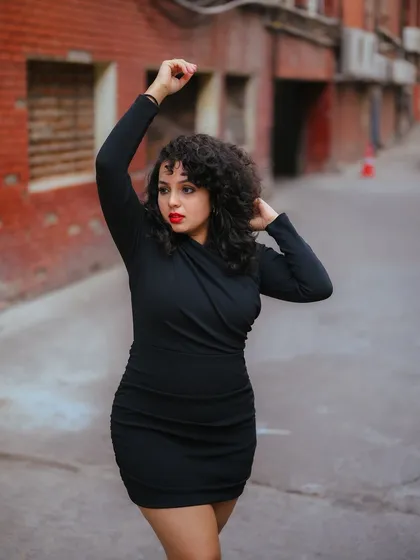 A duplicate of image 99, this dynamic portrait in a black dress against an urban alley is both powerful and expressive.