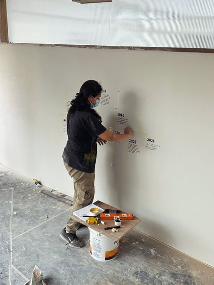 This timeline wall was created for the first Bangalore outlet of Deliciae Patisserie. It tells the story of their brand's journey through a combination of hand-lettering and mounted photographs, turning a simple wall into a narrative experience for their customers.