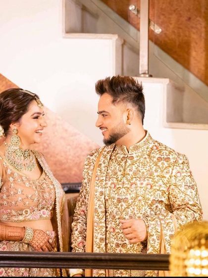 A happy moment between the couple. Her polki jewellery adds a touch of timeless grace to the modern outfit.